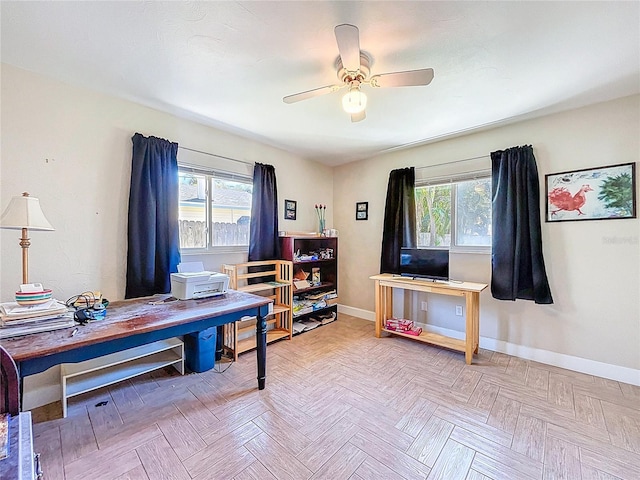 office featuring a wealth of natural light, baseboards, and a ceiling fan