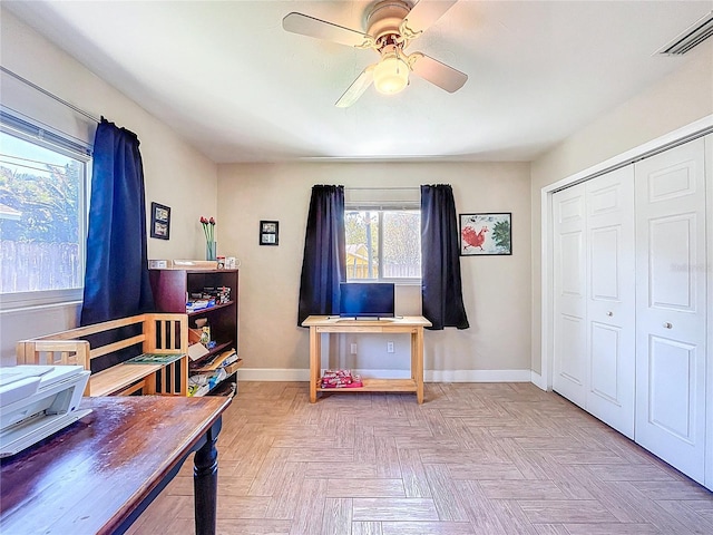 home office featuring visible vents, ceiling fan, and baseboards