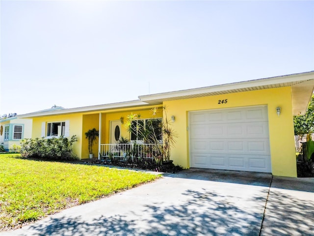 ranch-style house with stucco siding, driveway, a front yard, and a garage