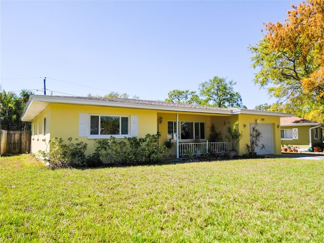 ranch-style house with stucco siding, a garage, a front yard, and fence