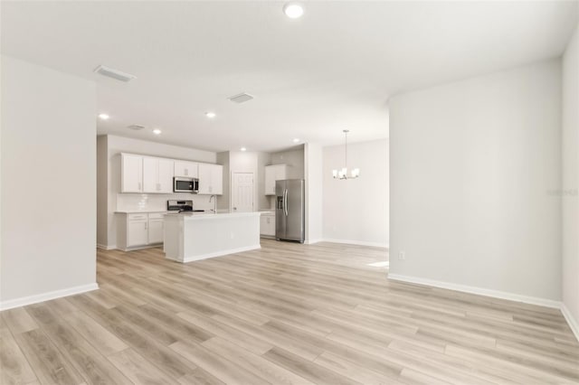 unfurnished living room with baseboards, recessed lighting, visible vents, and light wood-type flooring