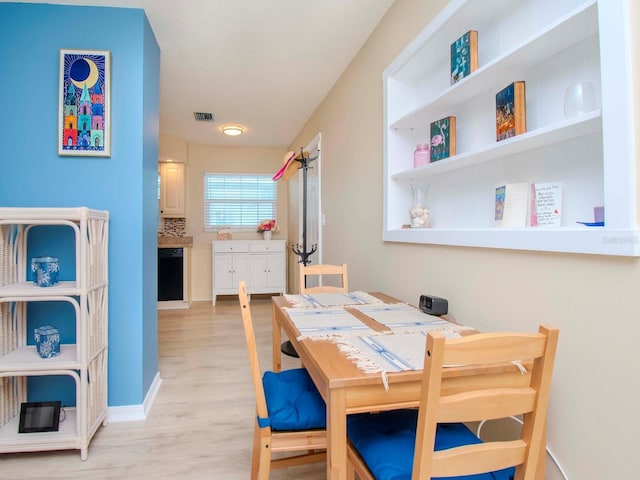 dining room featuring visible vents and light wood finished floors