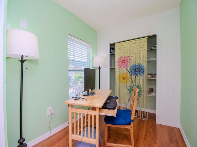 office space featuring baseboards and wood finished floors