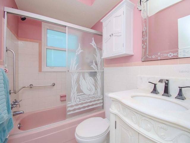 full bath featuring enclosed tub / shower combo, toilet, vanity, and tile walls