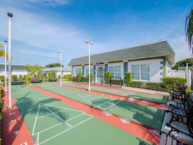 surrounding community featuring shuffleboard and fence