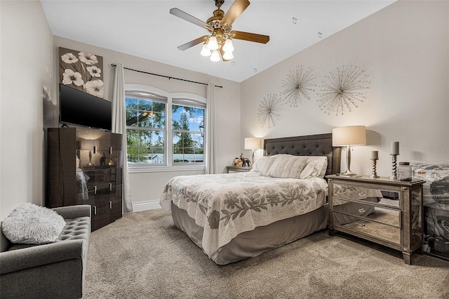 bedroom featuring vaulted ceiling, carpet, baseboards, and ceiling fan