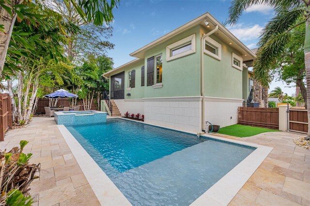 view of pool featuring stairway, a patio, a fenced backyard, and a pool with connected hot tub