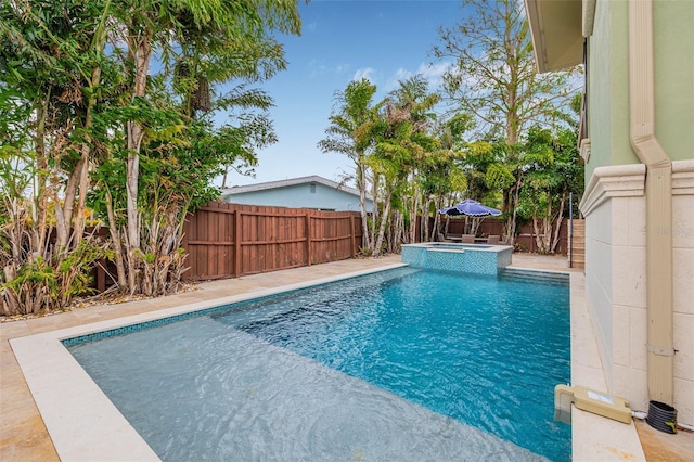 view of swimming pool with a pool with connected hot tub and a fenced backyard