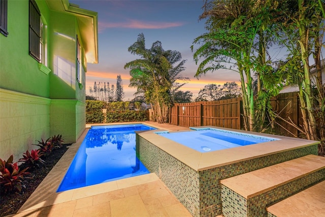 view of swimming pool featuring a fenced in pool, an in ground hot tub, and a fenced backyard