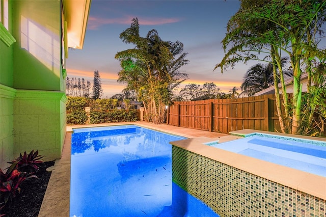 view of pool with a fenced in pool, an in ground hot tub, and a fenced backyard