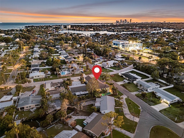 aerial view at dusk with a water view