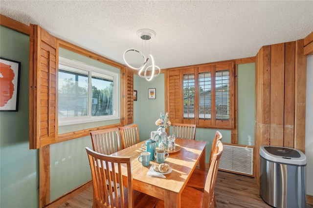 dining room featuring a wealth of natural light, visible vents, and wood finished floors