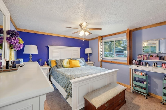 bedroom with ceiling fan, a textured ceiling, carpet, and ornamental molding