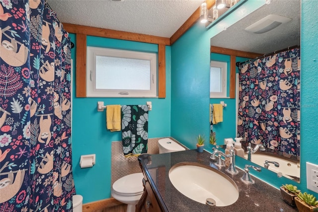 bathroom featuring curtained shower, a textured ceiling, vanity, and toilet