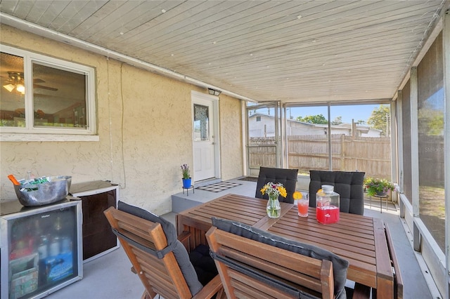 sunroom with beverage cooler and wooden ceiling