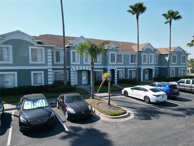 view of front of property with a residential view and uncovered parking