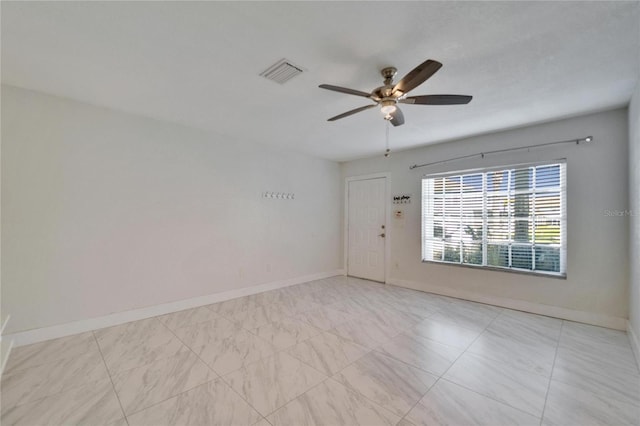 spare room featuring visible vents, baseboards, and ceiling fan