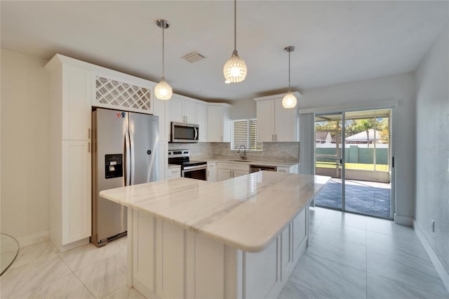 kitchen with visible vents, decorative backsplash, stainless steel appliances, white cabinetry, and a sink