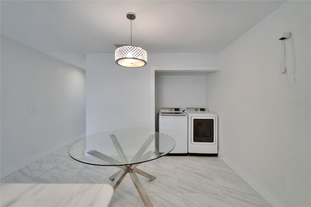 unfurnished dining area featuring baseboards, independent washer and dryer, and marble finish floor