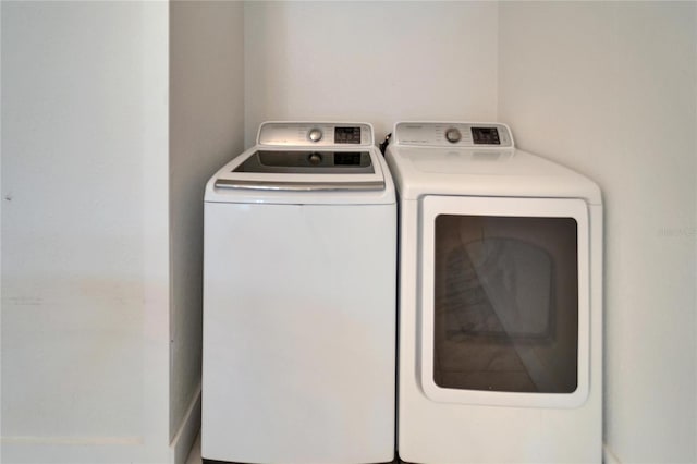 laundry area with washing machine and clothes dryer and laundry area