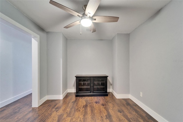 unfurnished room featuring baseboards, wood finished floors, and a ceiling fan