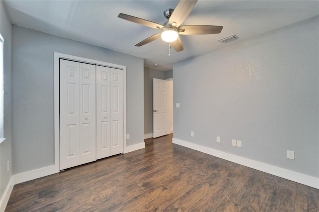 unfurnished bedroom with visible vents, baseboards, a closet, and wood finished floors