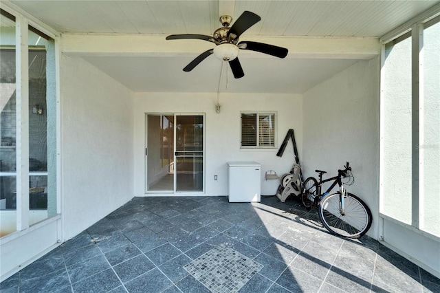 exterior space featuring a ceiling fan