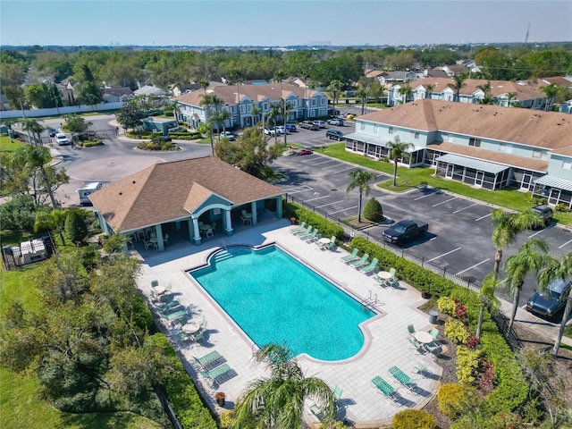 community pool with a patio and a residential view