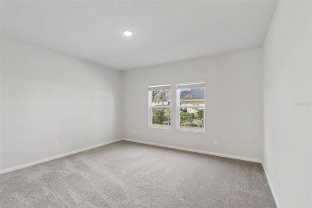 unfurnished room with baseboards and carpet floors