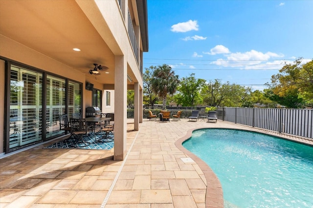 view of pool featuring a patio, fence, a fenced in pool, and ceiling fan