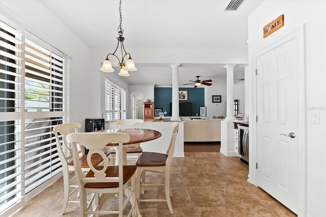 dining room with visible vents, beverage cooler, ceiling fan with notable chandelier, light tile patterned flooring, and decorative columns