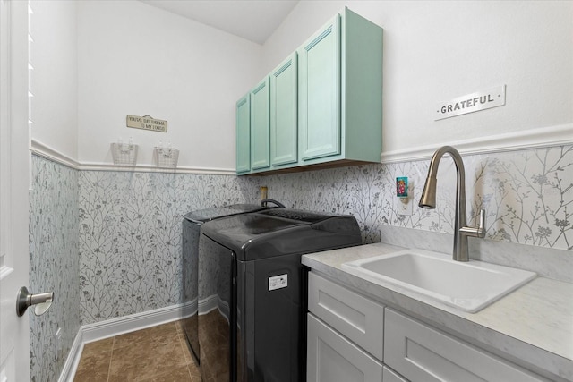 laundry area with washer and clothes dryer, cabinet space, wainscoting, and a sink