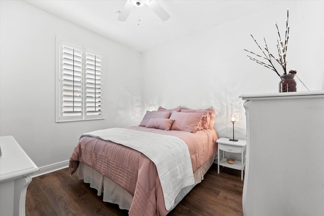 bedroom featuring baseboards, wood finished floors, and a ceiling fan