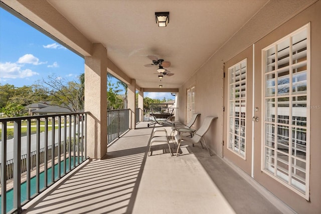 balcony featuring ceiling fan and a sunroom