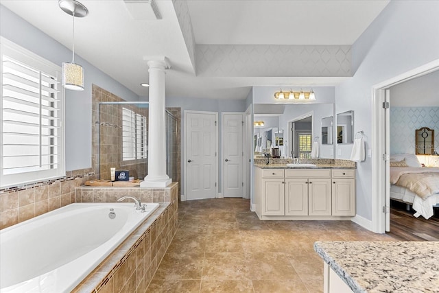 ensuite bathroom with a bath, a stall shower, ensuite bathroom, and ornate columns