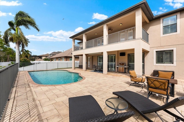 view of pool featuring a patio area, fence, a fenced in pool, and a grill