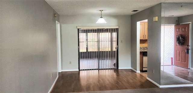 interior space with visible vents, a textured ceiling, and wood finished floors