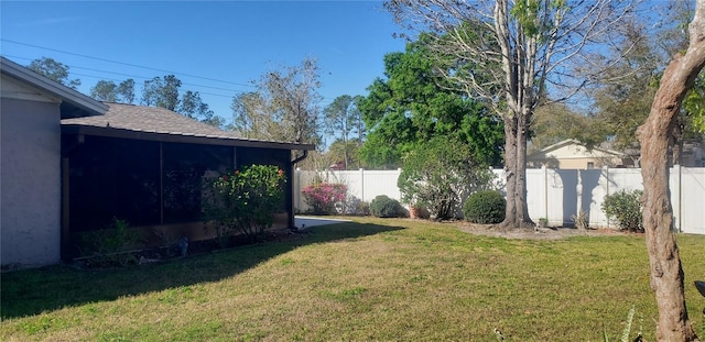 view of yard featuring a fenced backyard and a sunroom