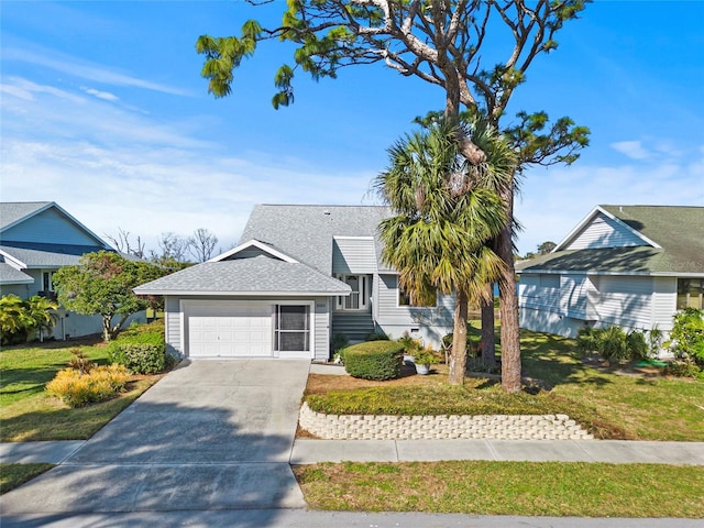 view of front of property featuring an attached garage, concrete driveway, a front lawn, and roof with shingles