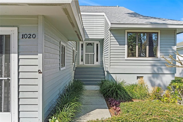 doorway to property featuring roof with shingles and crawl space