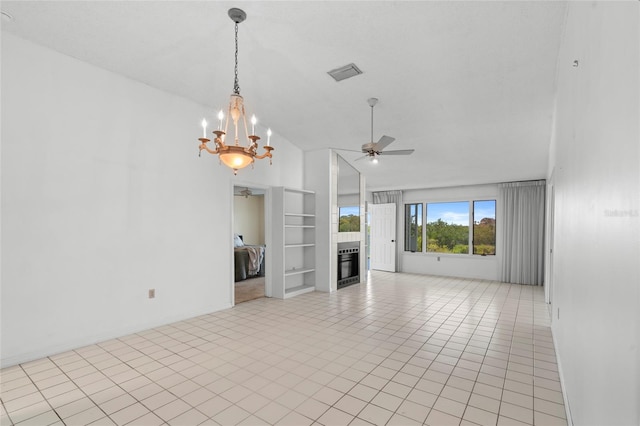 unfurnished living room featuring built in shelves, visible vents, light tile patterned flooring, a glass covered fireplace, and ceiling fan with notable chandelier