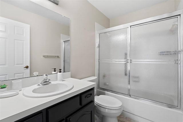 bathroom with vanity, toilet, and enclosed tub / shower combo