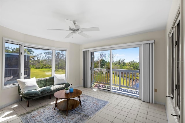 sunroom featuring a healthy amount of sunlight and a ceiling fan