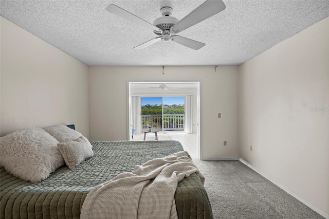 bedroom with access to exterior, a textured ceiling, carpet floors, baseboards, and ceiling fan