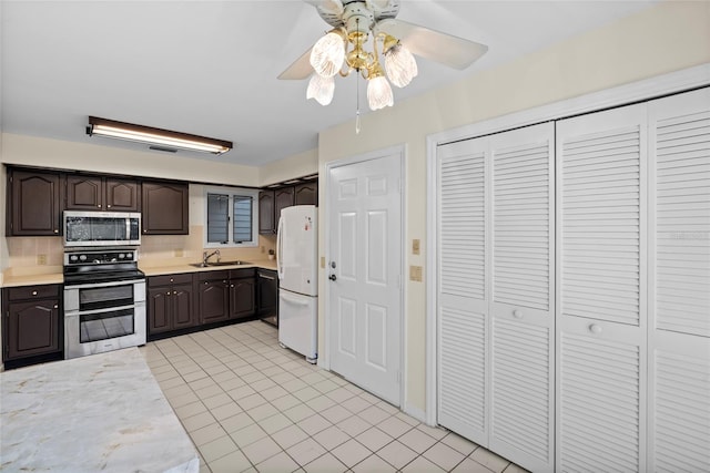 kitchen with a sink, decorative backsplash, light countertops, stainless steel appliances, and dark brown cabinets