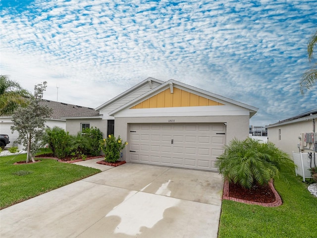 ranch-style home featuring an attached garage, driveway, and a front yard