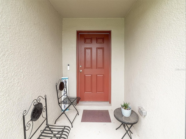 entrance to property with stucco siding