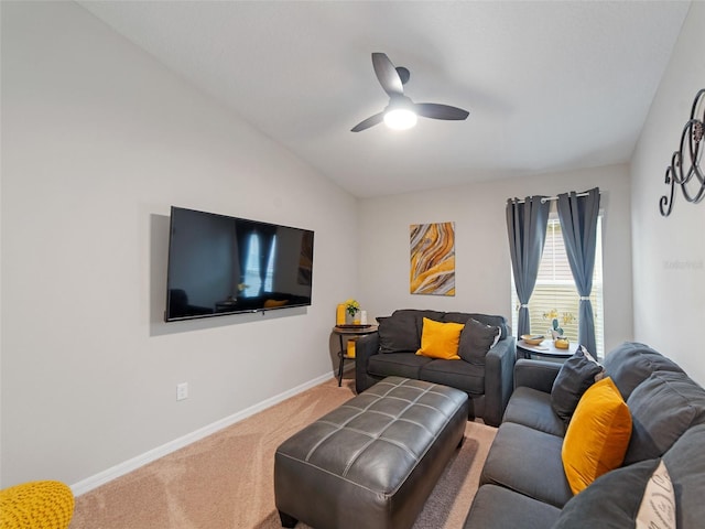 living area featuring a ceiling fan, vaulted ceiling, carpet, and baseboards