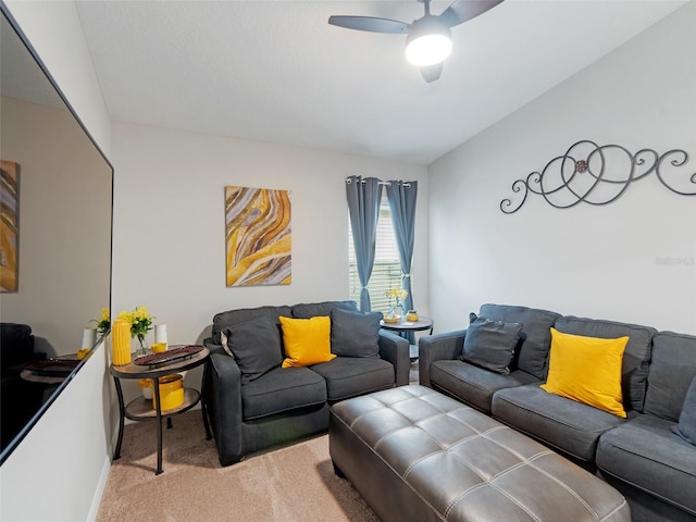 living room featuring light colored carpet, ceiling fan, and vaulted ceiling