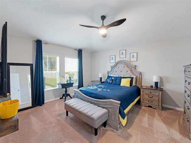 carpeted bedroom featuring ceiling fan and baseboards